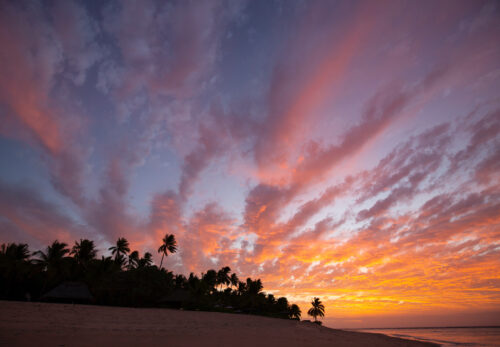 Spectacular color explodes during sunset over Tavarua Island.