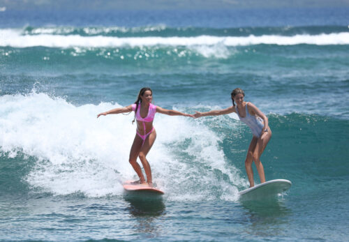 Sharing is caring as 2 best friends enjoy surfing at Kiddieland.
